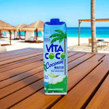 Vita Coco Coconut Water front label close-up on tropical patio, ultimate hydration from coconuts.