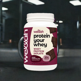 Wellah Dark Chocolate Protein Powder in gym setting