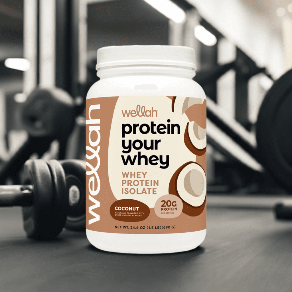 Buy Wellah Protein Your Whey – Coconut [30 Servings] | 20g Protein; whey protein isolate tub placed in gym setting, ideal for muscle recovery.