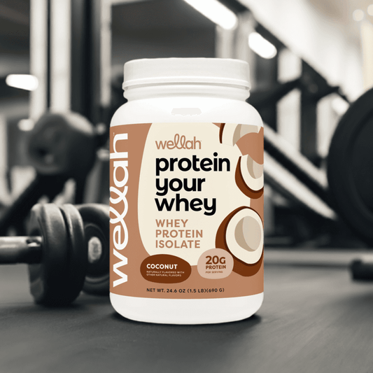 Buy Wellah Protein Your Whey – Coconut [30 Servings] | 20g Protein; whey protein isolate tub placed in gym setting, ideal for muscle recovery.