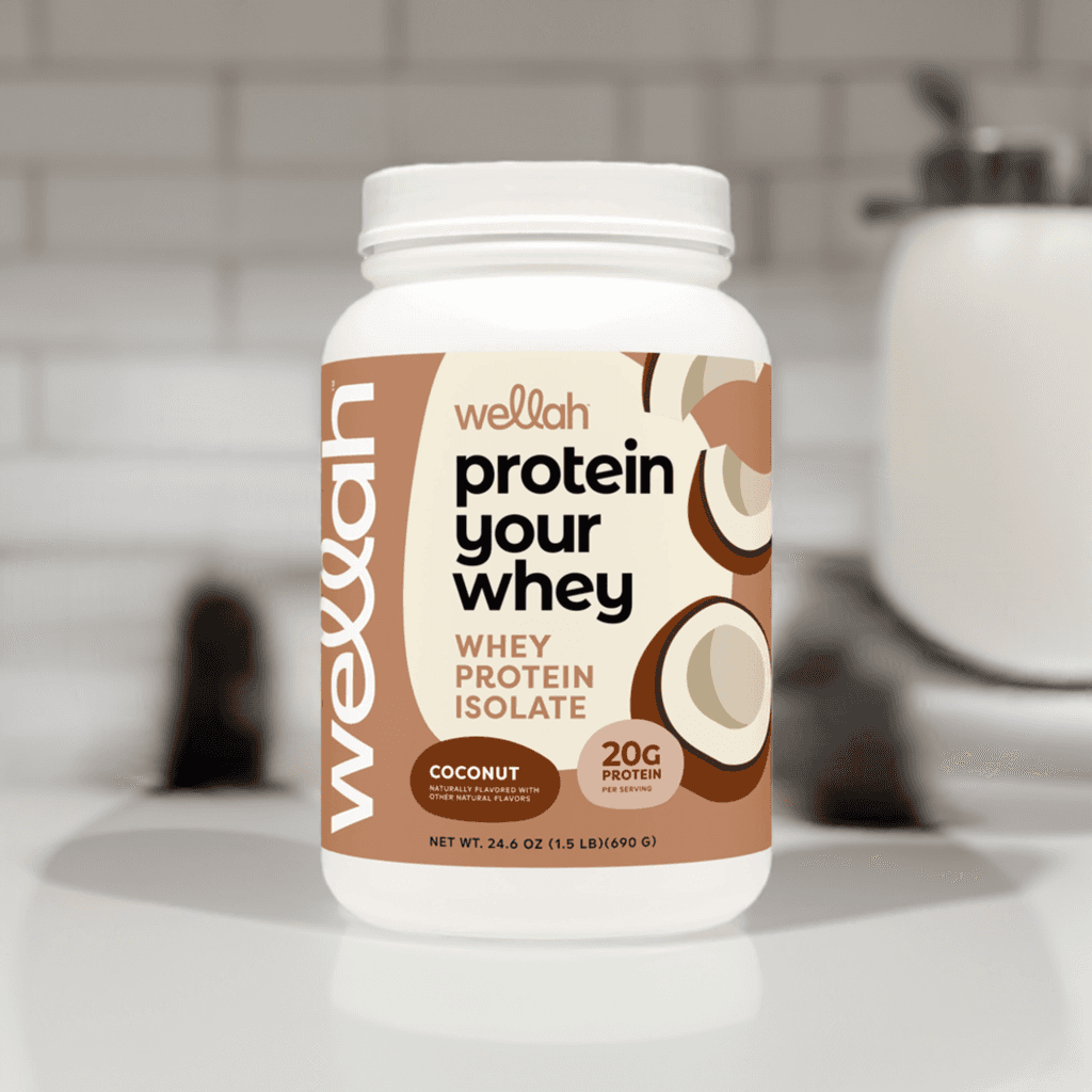 Buy Wellah Protein Your Whey – Coconut [30 Servings] | 20g Protein; coconut-flavored protein powder jar on kitchen counter, perfect for daily nutrition.