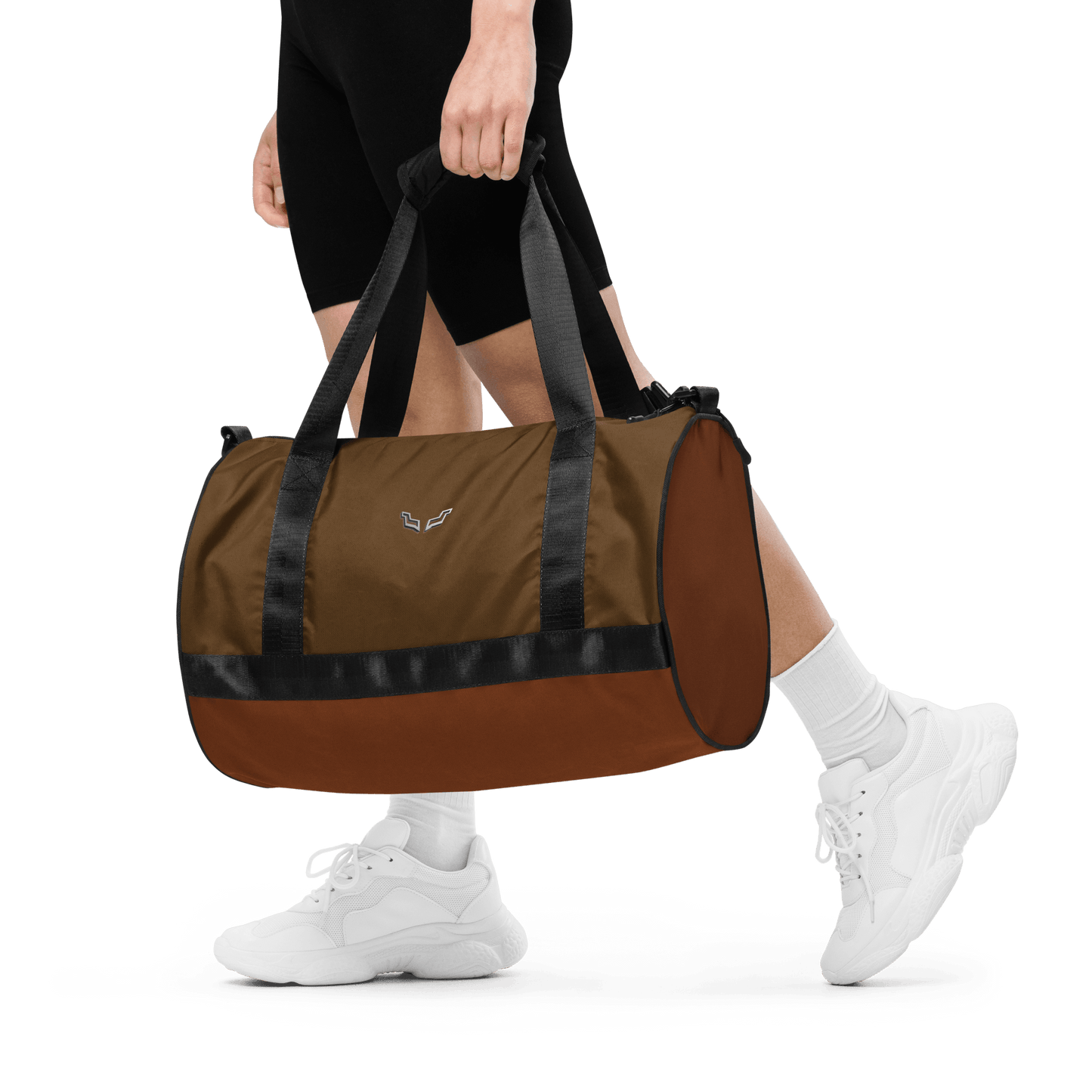 Person carrying the Velite Armor Gym Bag, demonstrating its portable size, padded handles, and sporty, durable construction.