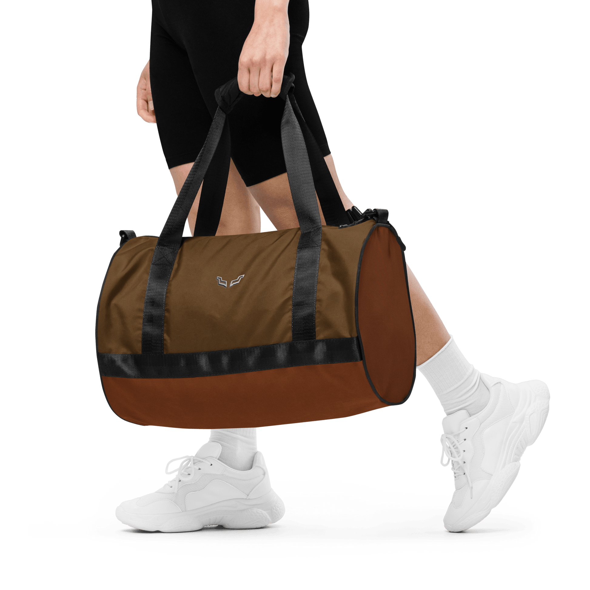 Person carrying the Velite Armor Gym Bag, demonstrating its portable size, padded handles, and sporty, durable construction.