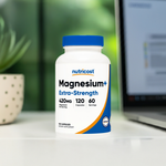 Magnesium+ Extra Strength Capsules near laptop