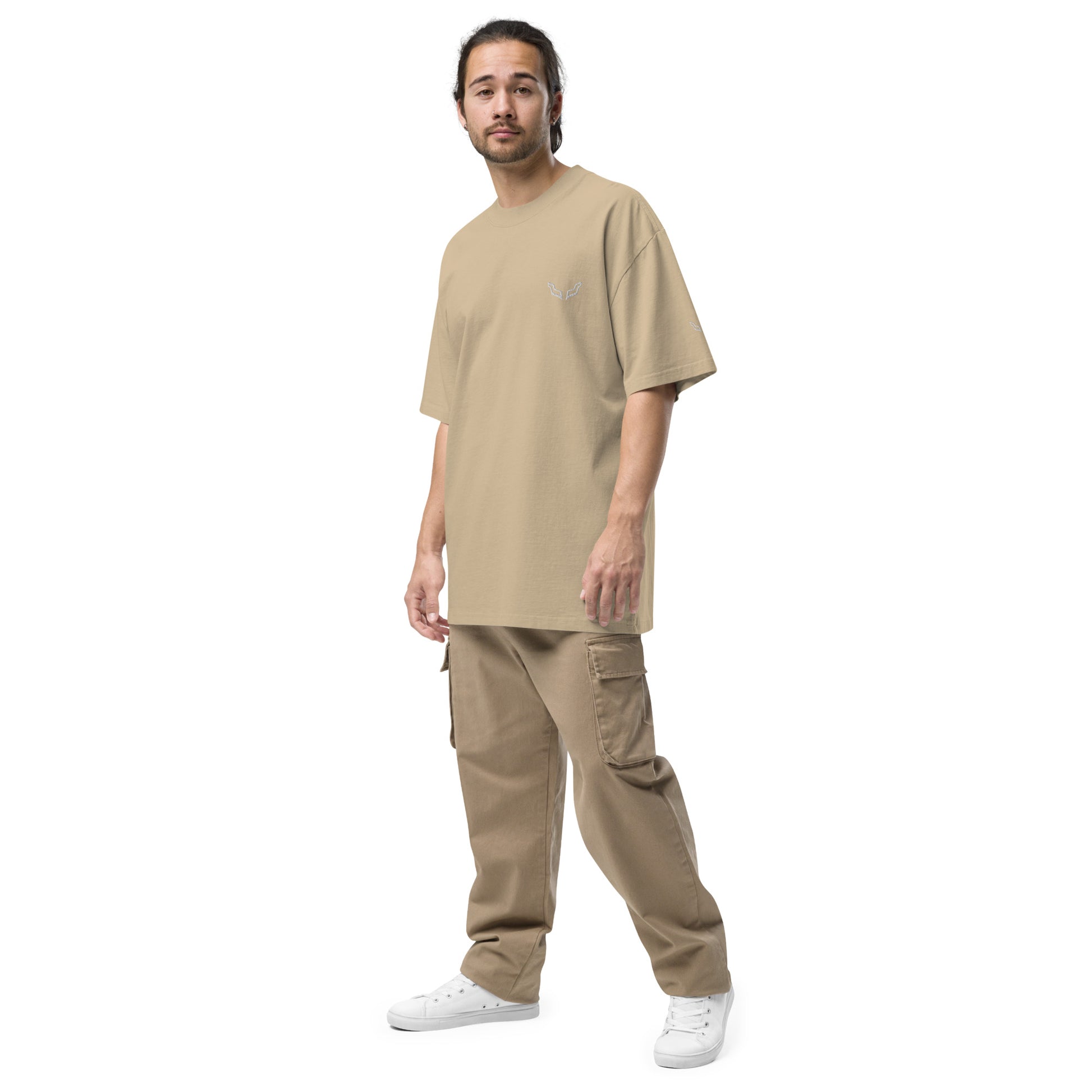 Model wearing Velite Armor Oversized Embroidered Tee – Premium Heavyweight in beige, styled with tan cargo pants and white sneakers.