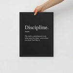 Hand holding the Discipline motivational framed poster 12x16 with elegant black background and white minimalist text – Velite Armor wall art