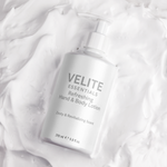 Velite Essentials Lotion - Vegan Hand Body Care bottle on creamy lotion background, highlighting its hydrating formula and texture.