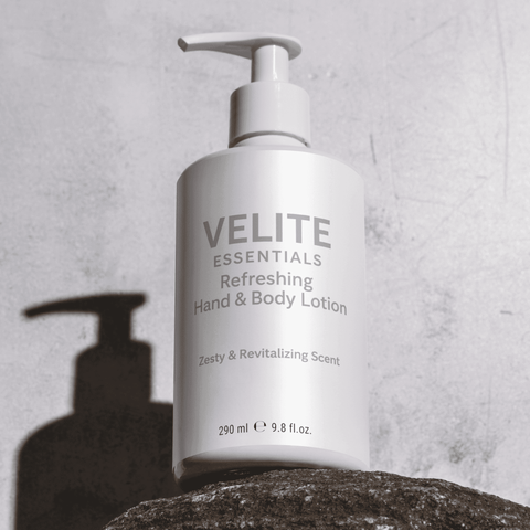 Velite Essentials Lotion - Vegan Hand Body Care bottle on stone with shadow, highlighting its clean, minimalist packaging design.