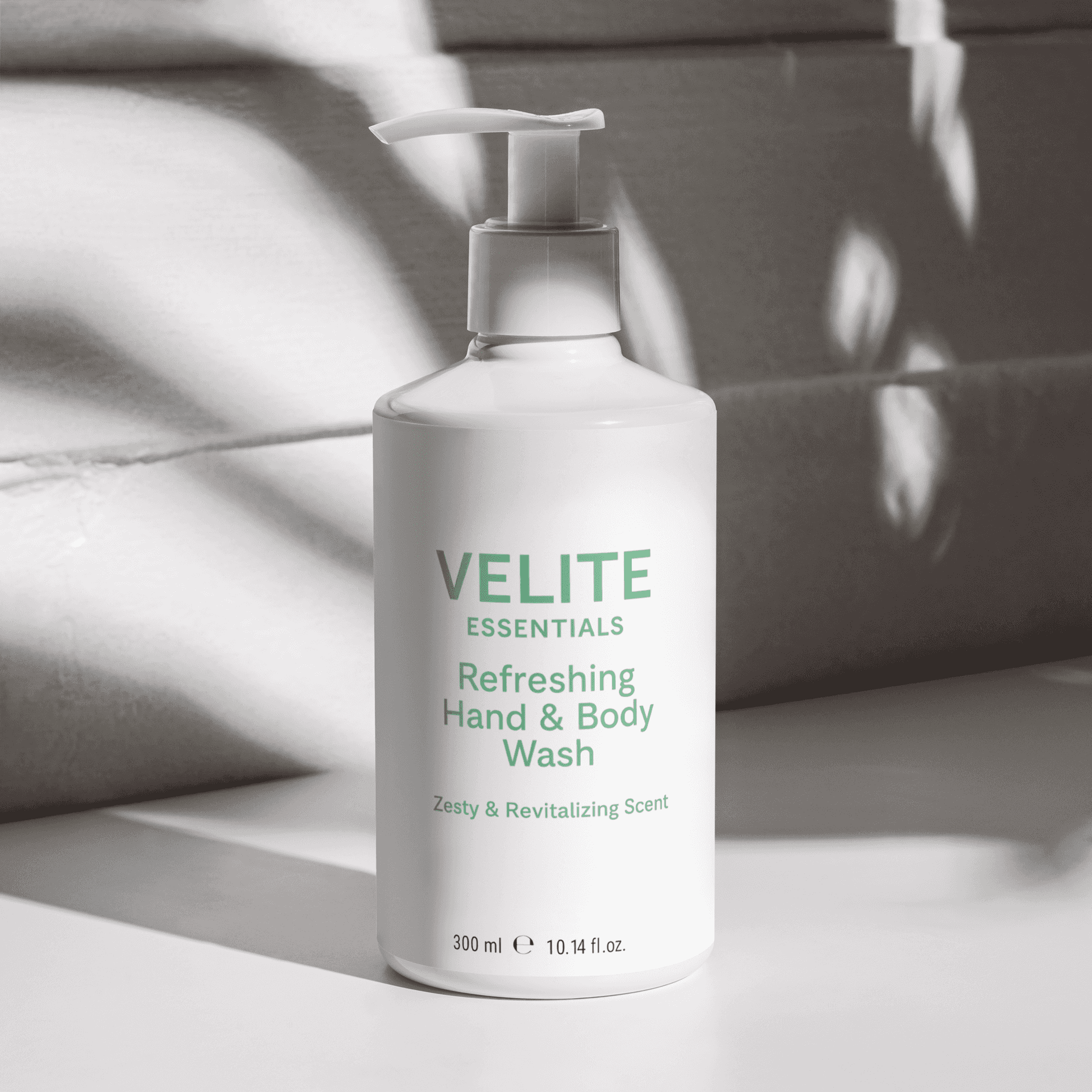 Velite Essentials Citrus Fresh Body Wash in natural light with shadows, emphasizing its ECOCERT-certified, vegan skincare appeal for soft, refreshed skin.