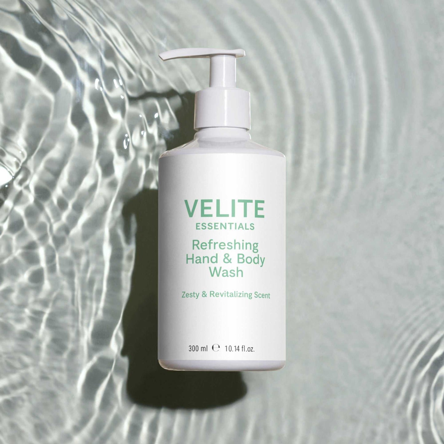 Velite Essentials Citrus Fresh Body Wash on rippling water background, highlighting its hydrating and vegan-friendly formula for daily cleansing.