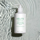 Velite Essentials Citrus Fresh Body Wash on rippling water background, highlighting its hydrating and vegan-friendly formula for daily cleansing.