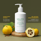 Velite Essentials Citrus Fresh Body Wash with quince fruit on wooden stand, promoting its natural, vegan formula and revitalizing citrus scent.