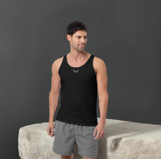 Male model wearing a black Velite Armor tank top with embroidered logo on the chest, designed for athletic performance and everyday comfort.