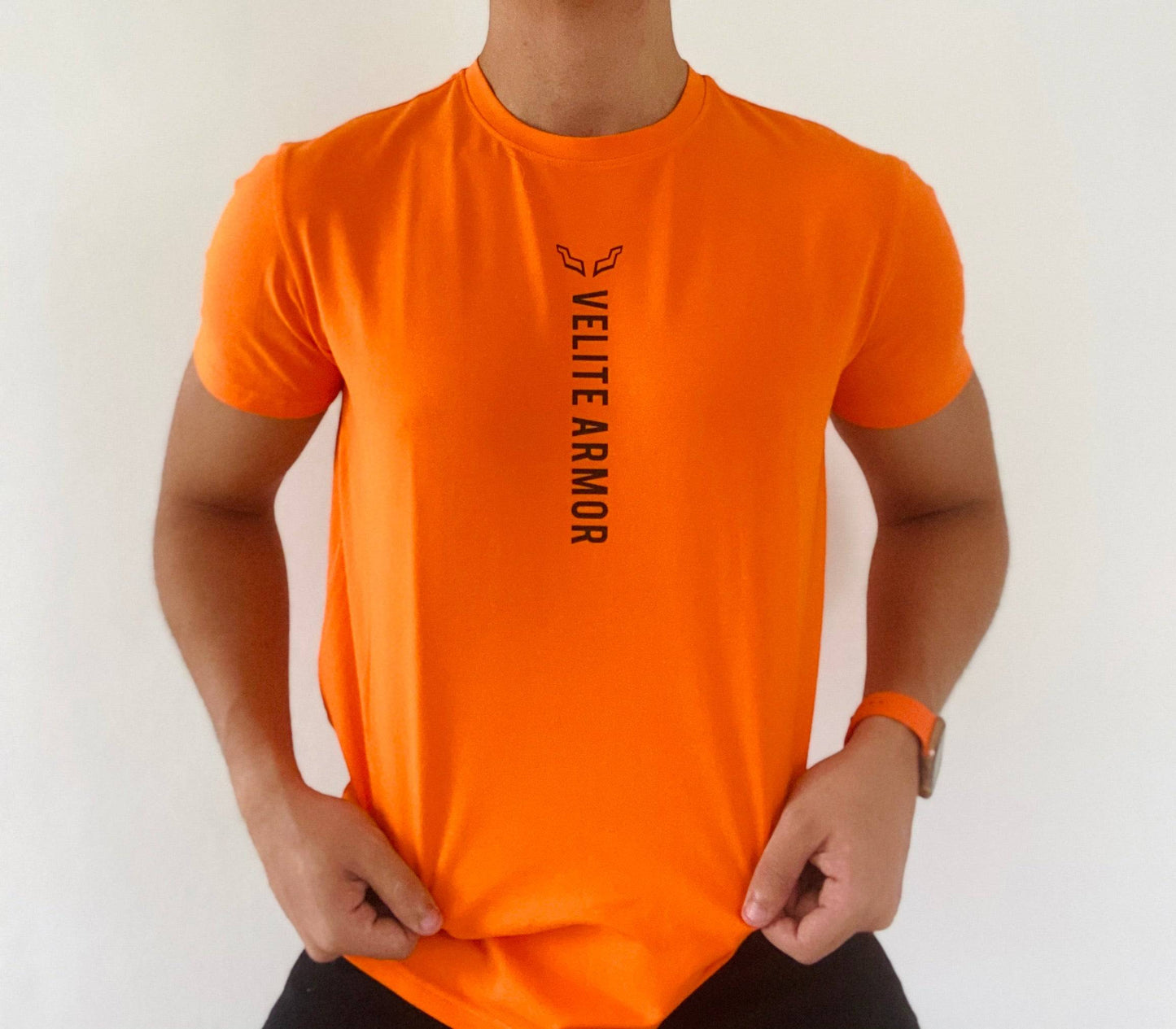 Close-up of Velite Armor Royalty Orange Slim Fit Tshirt highlighting soft fabric, vertical logo design, and snug athletic fit.