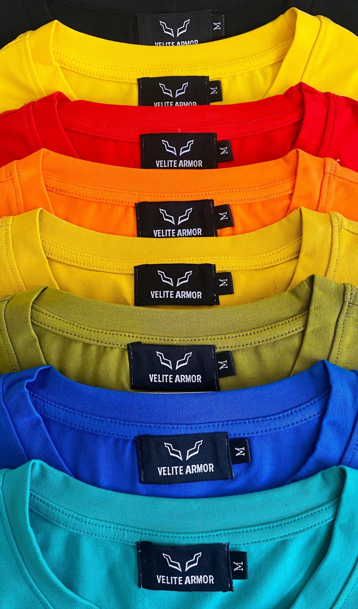 Top-down view of Velite Armor Royalty Slim Fit Tshirts in multiple colors, showcasing neckline tags and color range.