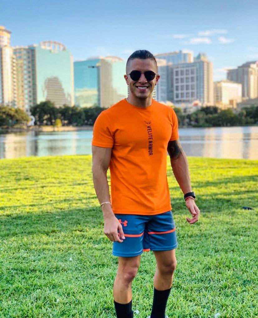 Velite Armor Royalty Orange Slim Fit Tshirt worn outdoors, showcasing activewear style and athletic fit for casual or workout use.