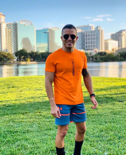 Velite Armor Royalty Orange Slim Fit Tshirt worn outdoors, showcasing activewear style and athletic fit for casual or workout use.