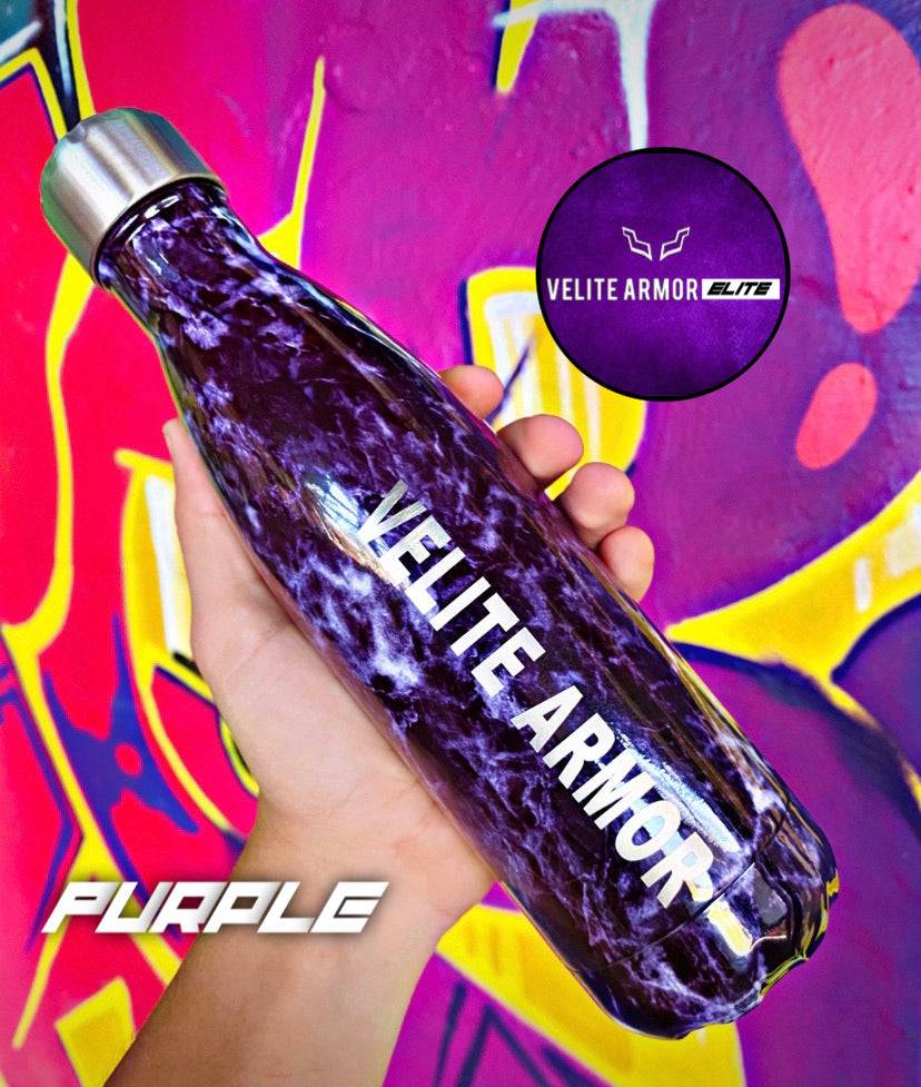 Velite Armor (ELITE) Water Bottle 17oz in vibrant purple marble, premium insulated bottle held against colorful graffiti wall.